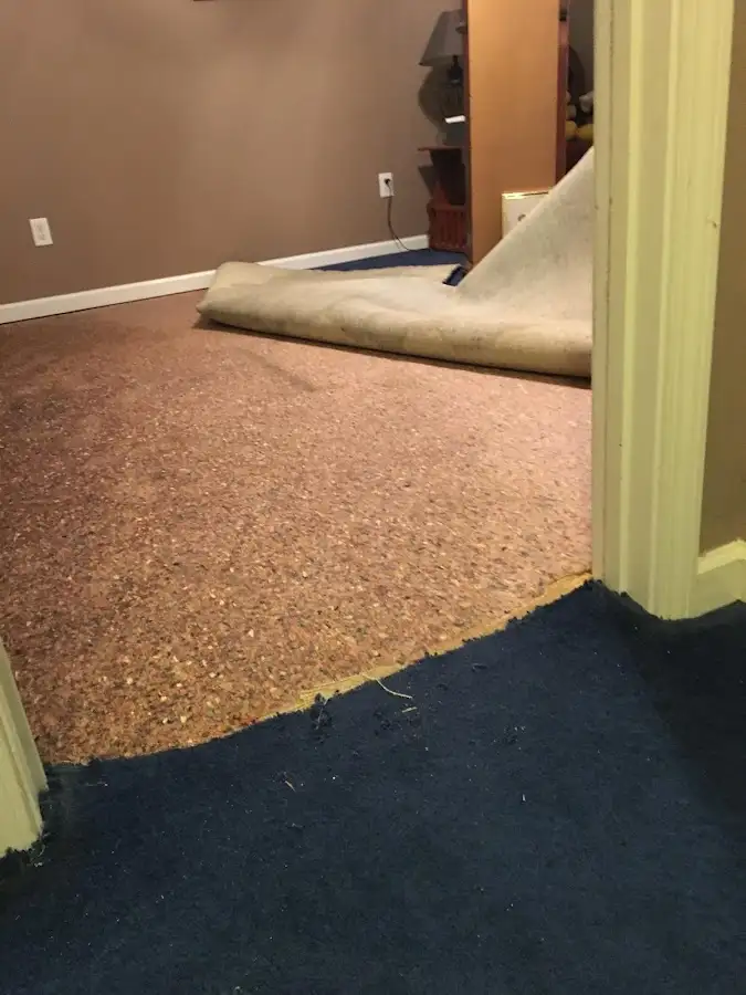 Carpet pad removal revealing water damage during Water Mitigation Services in Sun Village